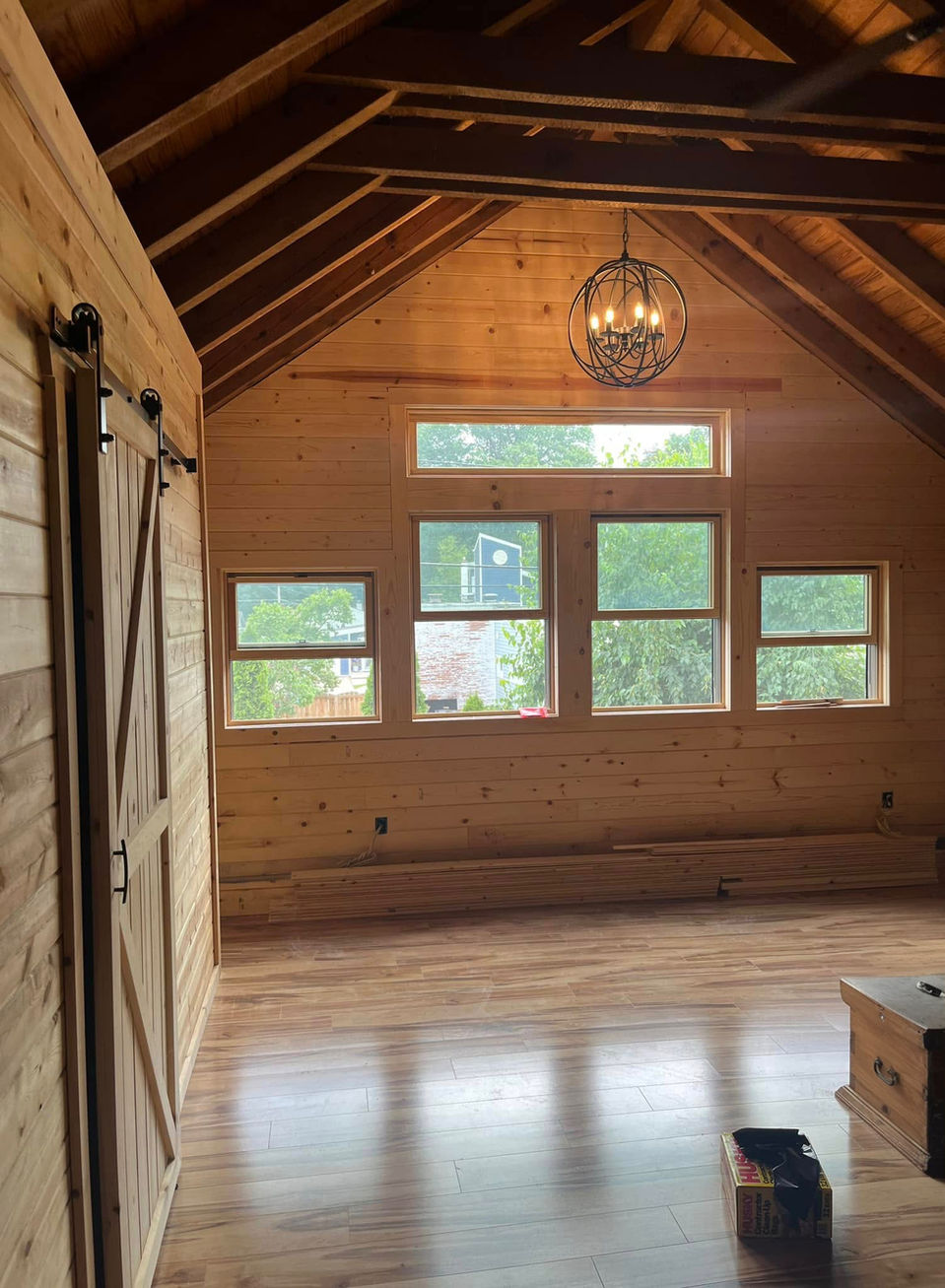 Great room of the log cabin taken from in the inside facing the many windows