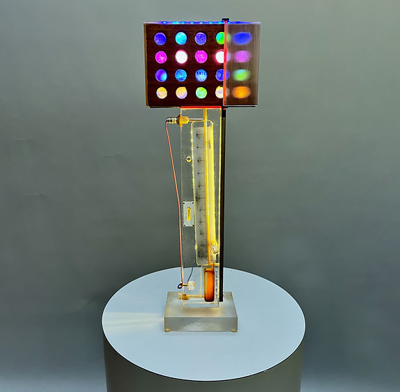 Illuminated sculpture uniting a vintage French densimeter with a grid of colored lights, merging science and luminous design.