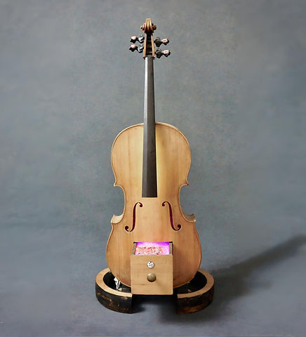 Wooden cello sculpture with porcelain busts of women as tuning pegs and a glowing drawer filled with glass beads