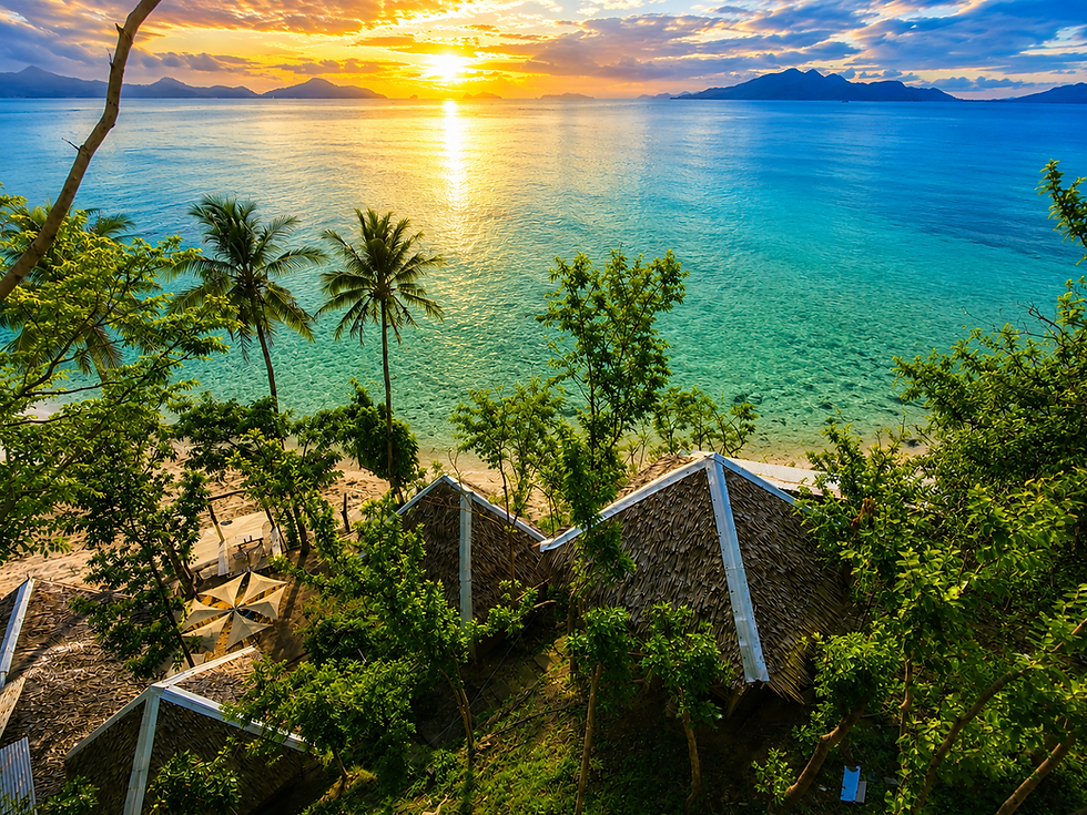 Kamp Tapik El Nido bungalows at sunrise over tropical sea