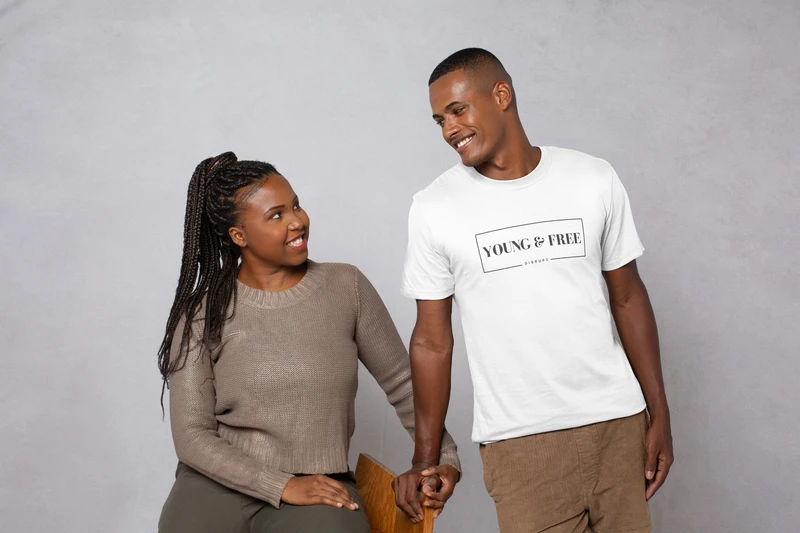 A woman and man looking at each other smiling. 