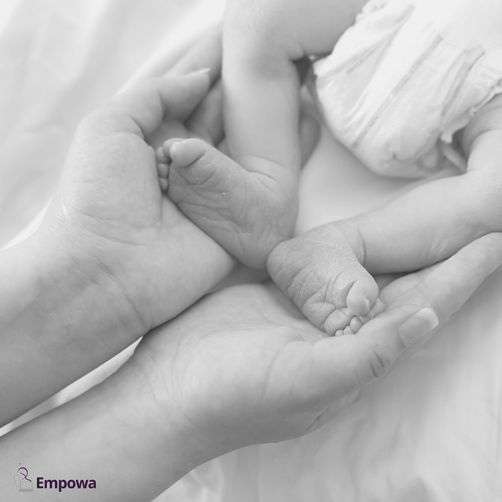 new mum holding newborn feet in preparation for bicycle legs movement