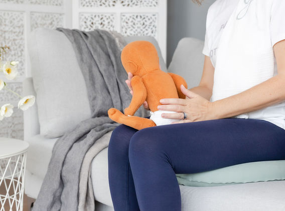 Kathy Rougier demonstrating burping techniques for babies