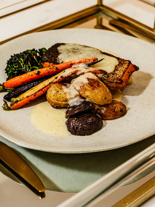 Cuisine Dish of Cooked Salmon and sautéed vegetables