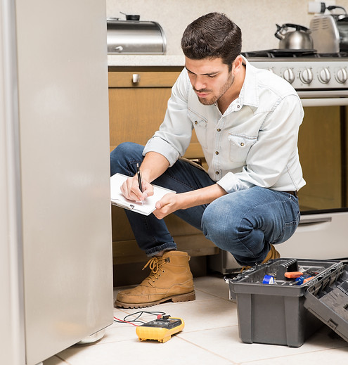 portrait-handsome-male-technician-doing-work-report-broken-fridge-home-kitchen.jpg