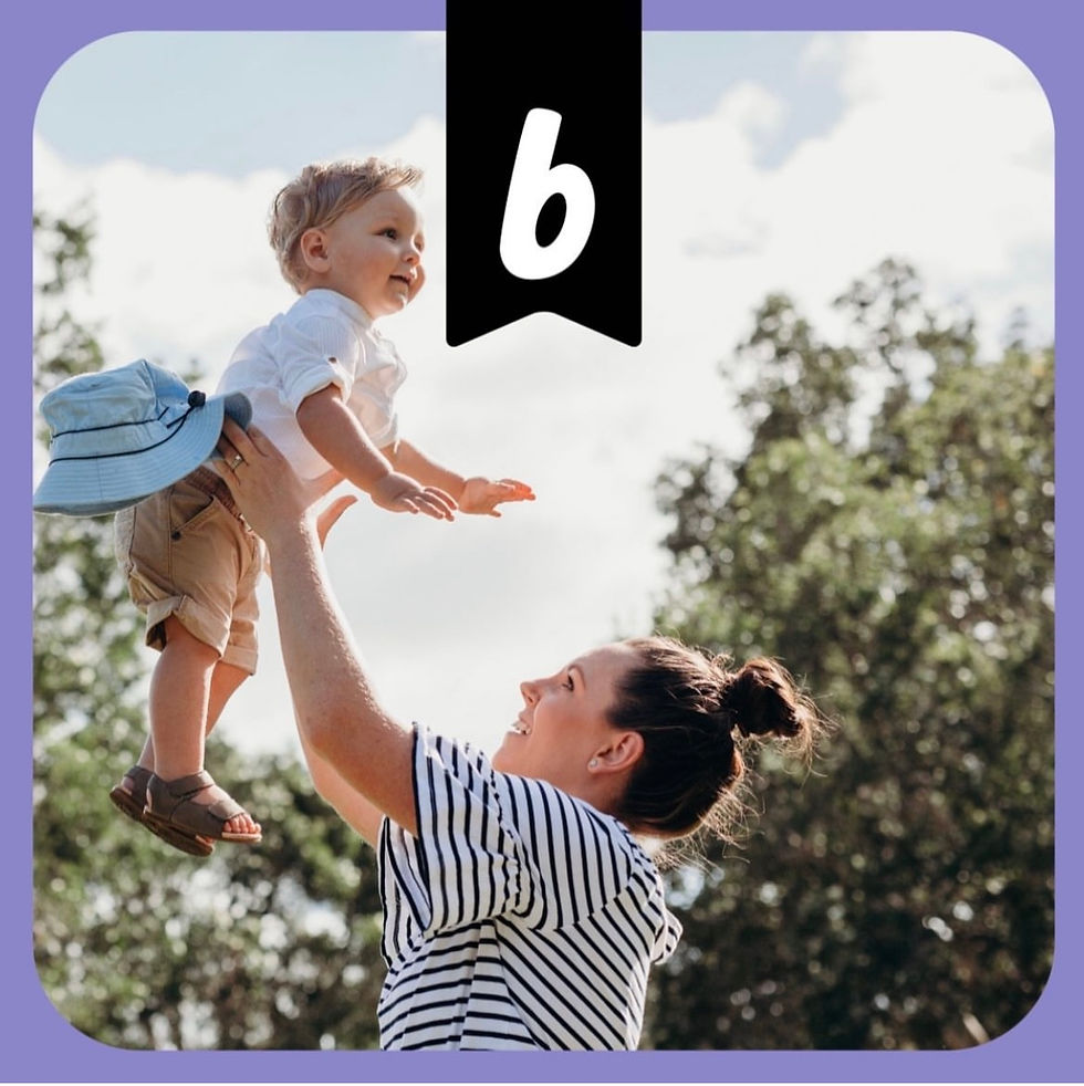 Photo of a young woman holding a baby high in the air. There are trees and blue sky and it looks like a beautiful day. The photo has a lavender border and Bundle logo.