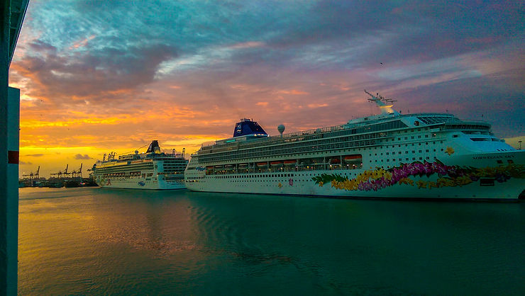 Sunrise behind Norwegian Pearl and Norwegian Sky in Port of Miami