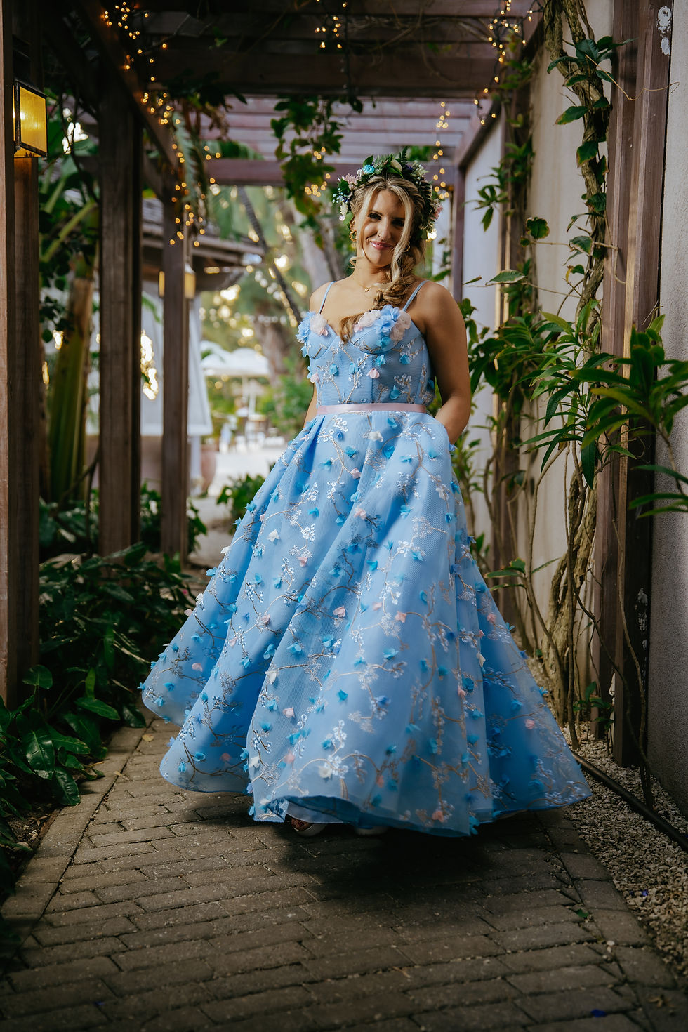 Close-up of the stunning blue wedding dress hung against a floral backdrop