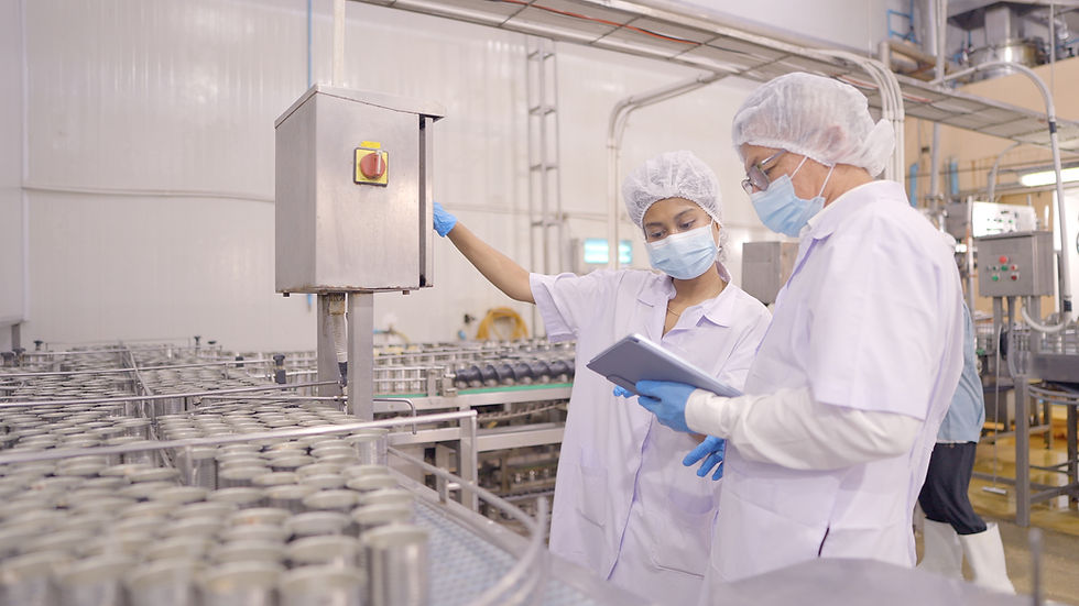 Engineers are checking the machinery system of a ready-to-eat food packaging machine in a food processing plant. Employee working in food processing production line. Quality control. Manufacturing industry, factory