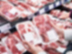 Hand with package meat beef in store