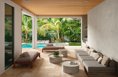 Inviting covered backyard space by Vee Merklen Interior Design in Delray Beach, FL, offering stylish seating and a beautiful poolside retreat.