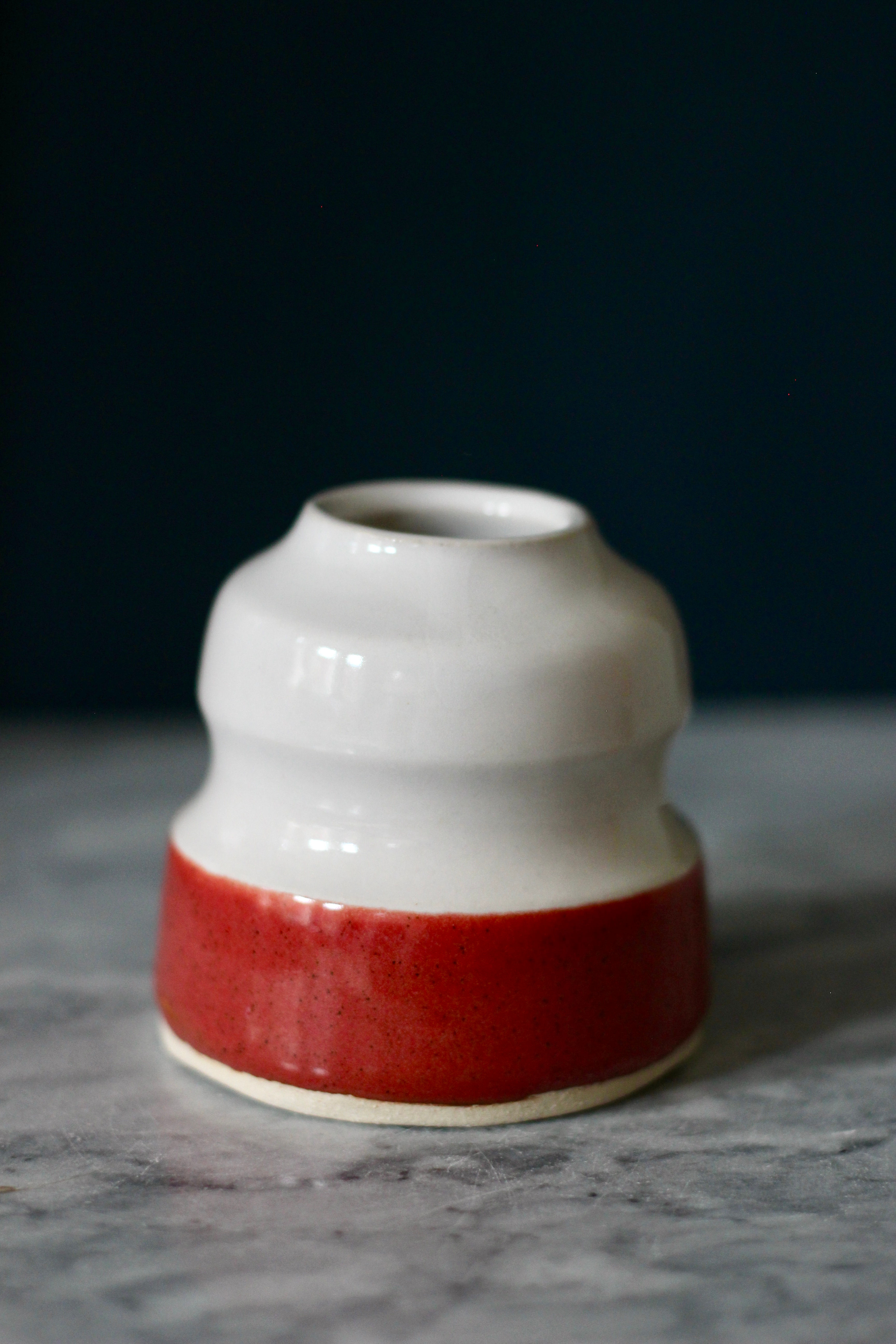 Hand thrown stoneware pottery curvy bud vase white and red glaze