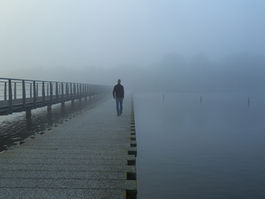 man walking in the fog