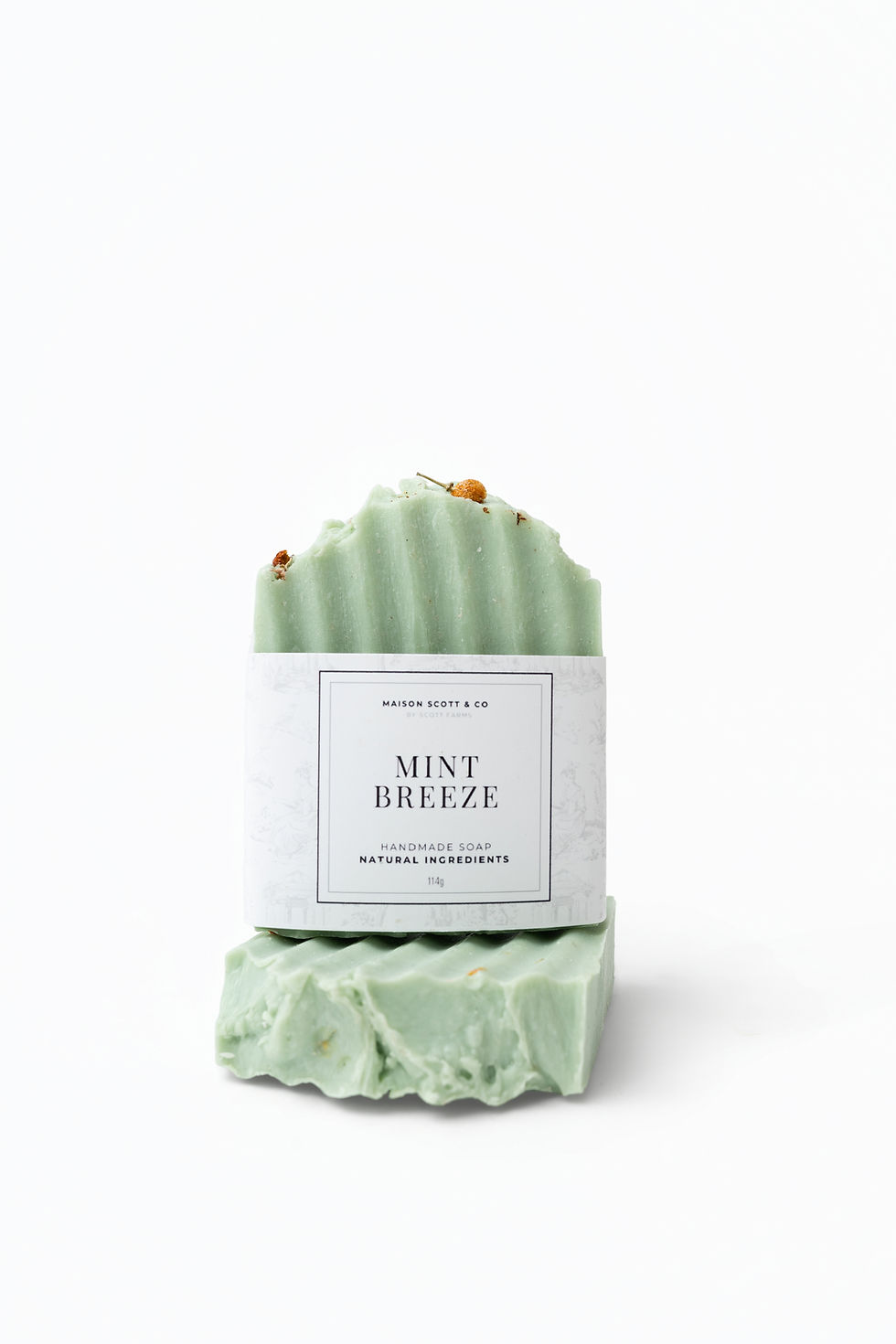 Green soap labeled "MINT BREEZE" on white background, natural soap product.