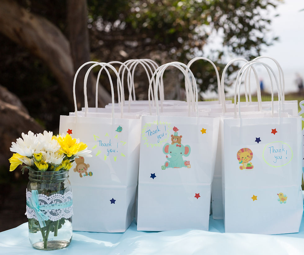 A table with a lot of kids goodie favour bags with thank you note