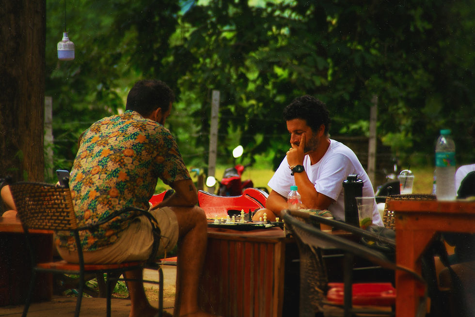 Two men play chess at Pai Market, thailand