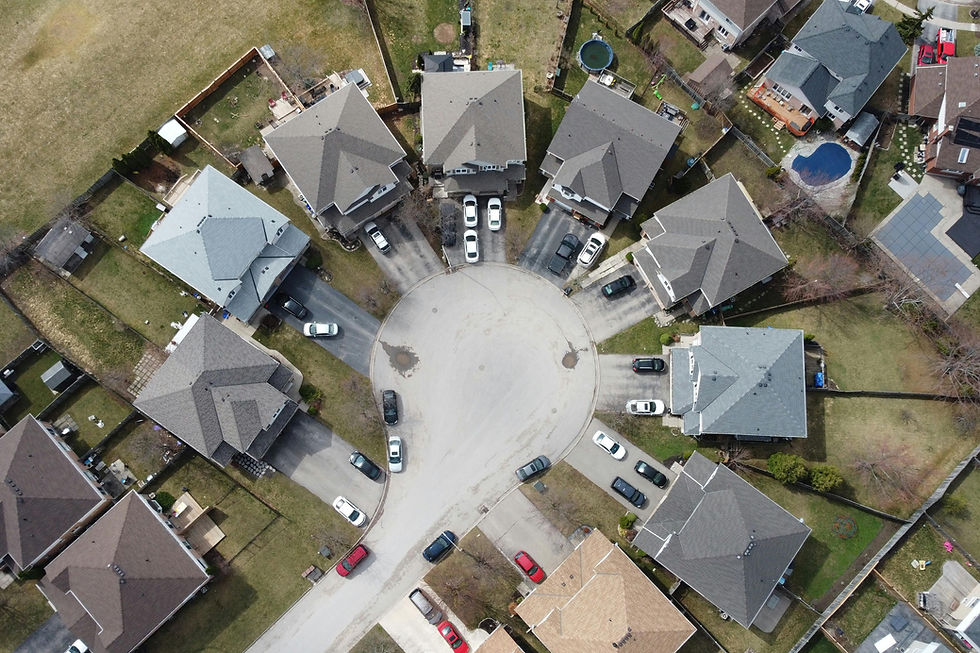 Aerial drone view of a residential neighbourhood in the Niagara Region showing homes and green spaces — Air Unlimited real estate aerial videography