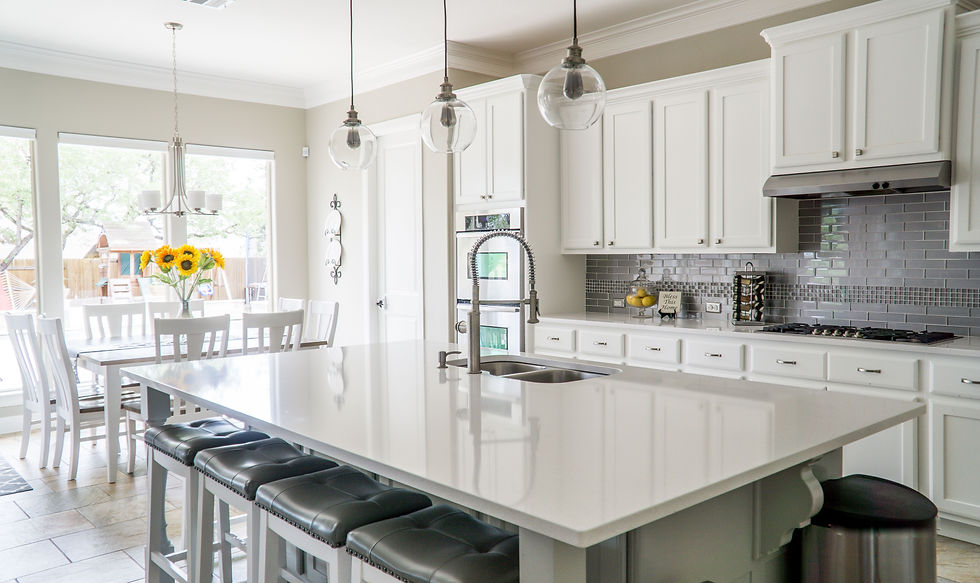 Professional real estate photography shoot at an Edmonton luxury property — photographer capturing interior details with professional lighting equipment for high-end listings