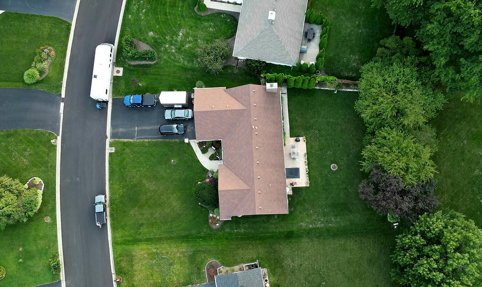 Aerial drone view of luxury homes in a residential community showing property boundaries and neighbourhood layout