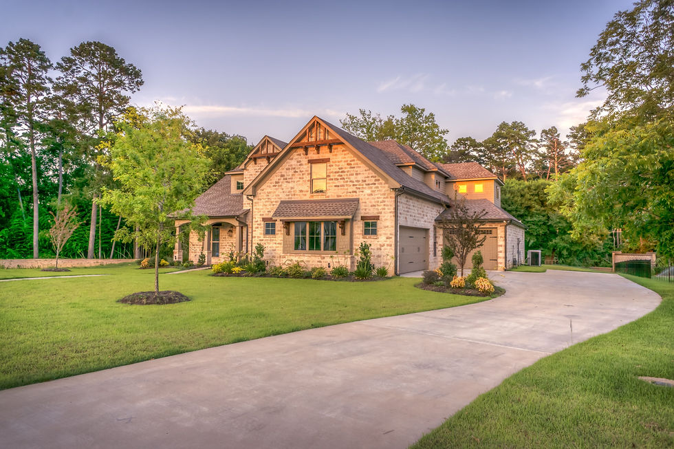 Aerial-style view of a stone estate home with a sweeping driveway and landscaped grounds — the kind of Niagara-on-the-Lake estate listing that drone photography sells
