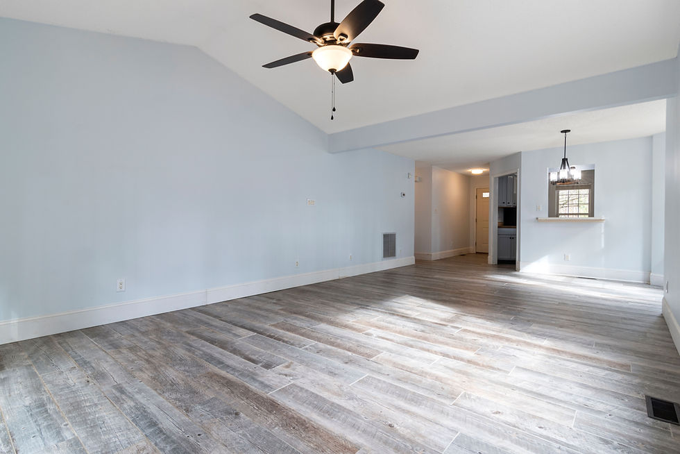 Bright vacant rental suite in an Edmonton multi-family building photographed for an investment property listing — showing true room proportions, flooring condition and natural light