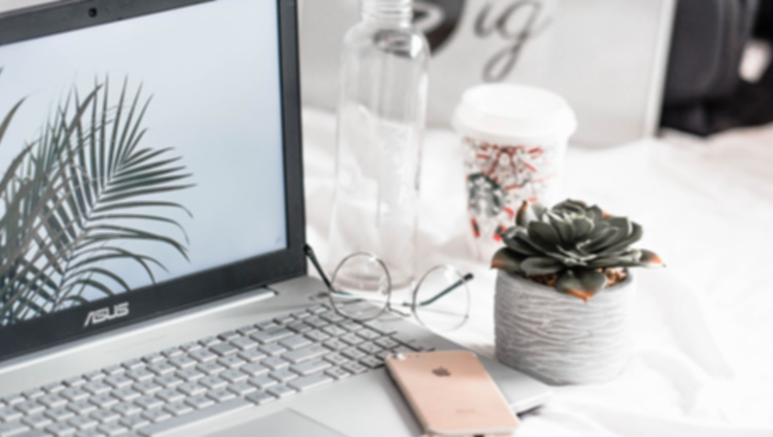 turned-on Asus laptop near eyeglasses, s