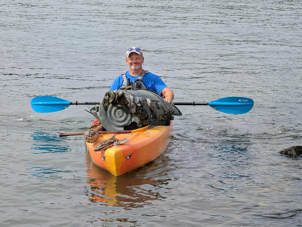 Kayaker Andy-Sitison returns with his catch during NAPS’ Cockrells Creek Cleanup