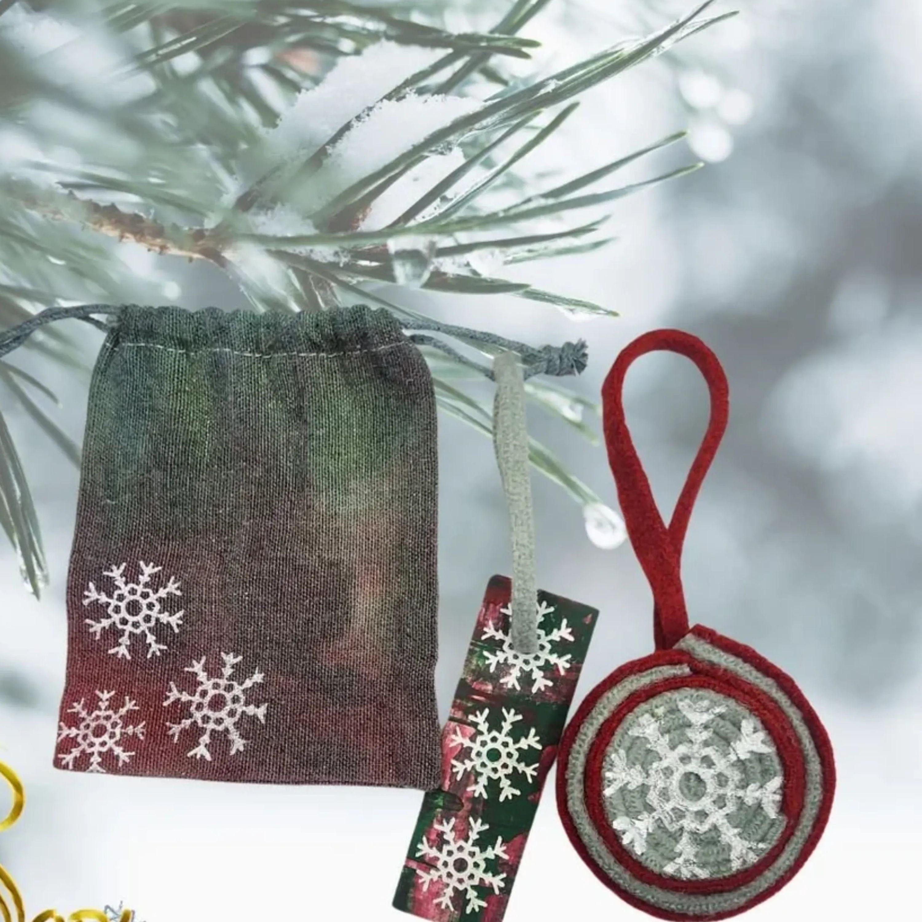 Front view of the Green and Red Wool Ornament, highlighting the hand-screened Snowflake Graphic. (Condition: Handmade)