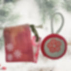 Front view of the Green and Red Wool Ornament, highlighting the screen-printed ROC Flower Graphic. (Condition: Handmade)