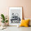 Thumbnail: Bright living space showing the St Louis Skyline Art Print leaning against a beige wall next to a yellow pillow and rubber pl
