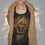 Thumbnail: A woman modeling the Medusa Graphic Racerback Tank, layered under a cozy cardigan, showcasing the fierce golden design.