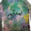 Thumbnail: Close-up of the black Winged Warrior figure and yellow ROC Mandala monoprint on the back of the M tie-dyed hoodie.