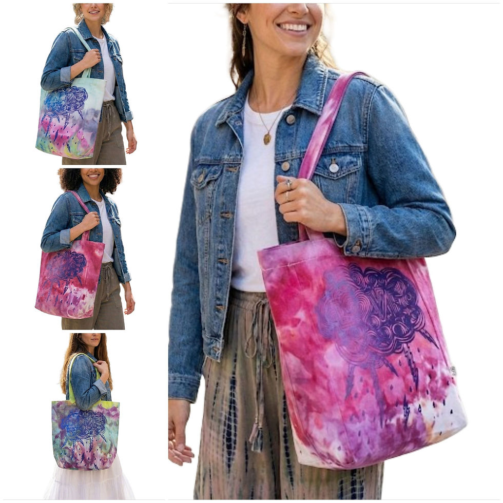 Model wearing a denim jacket holding the colorful Love Struck Ice Dyed Tote featuring a screen printed cloud heart design.