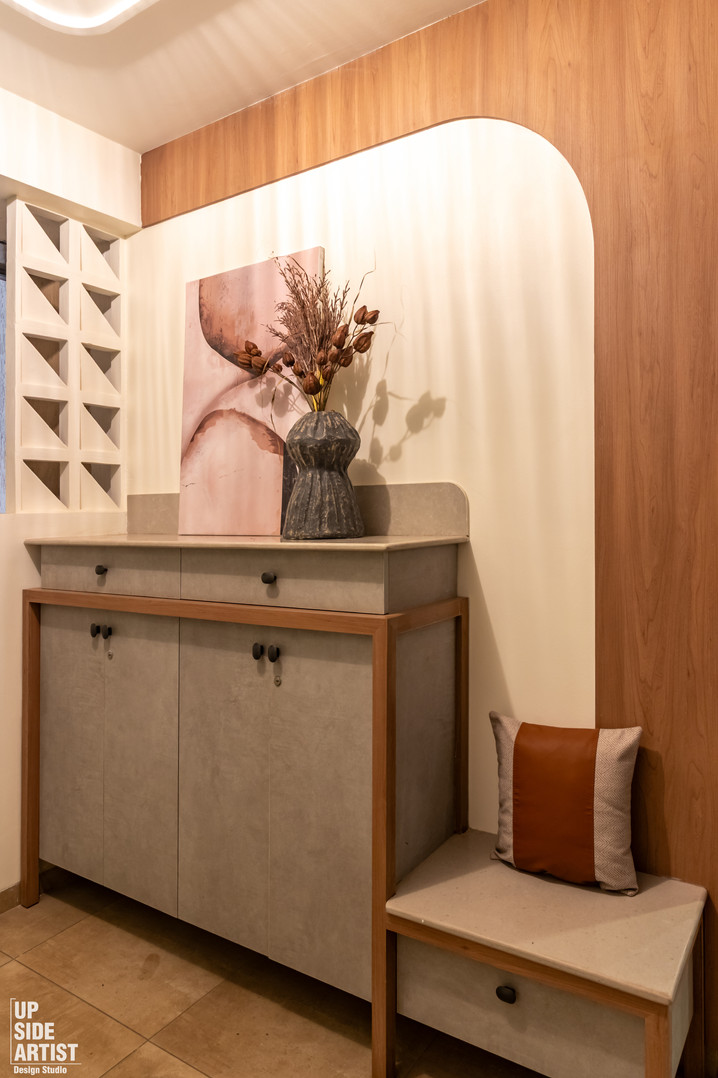 Contemporary home foyer showcasing a built-in grey cabinetry console, a small entryway bench with a leather cushion, and an arched timber wood wall accent.