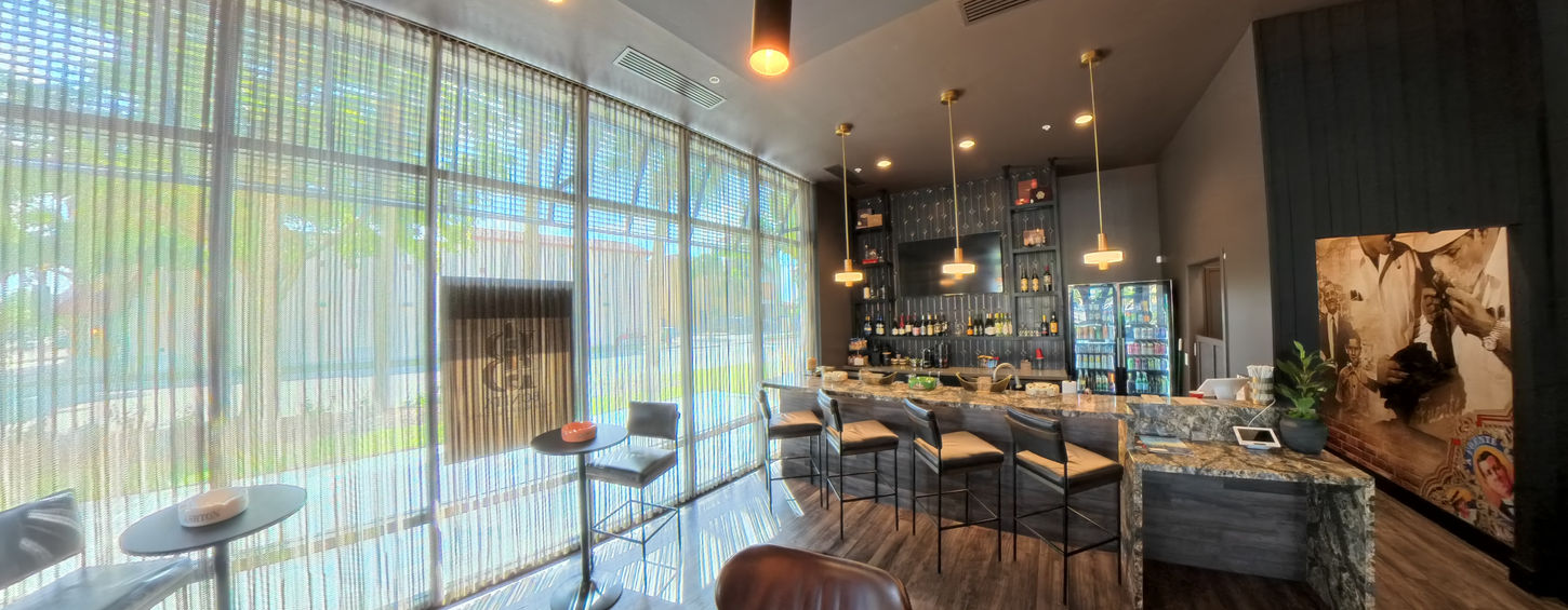 Finished cigar lounge bar in Bonita Springs Florida with stone counter and hospitality lighting.