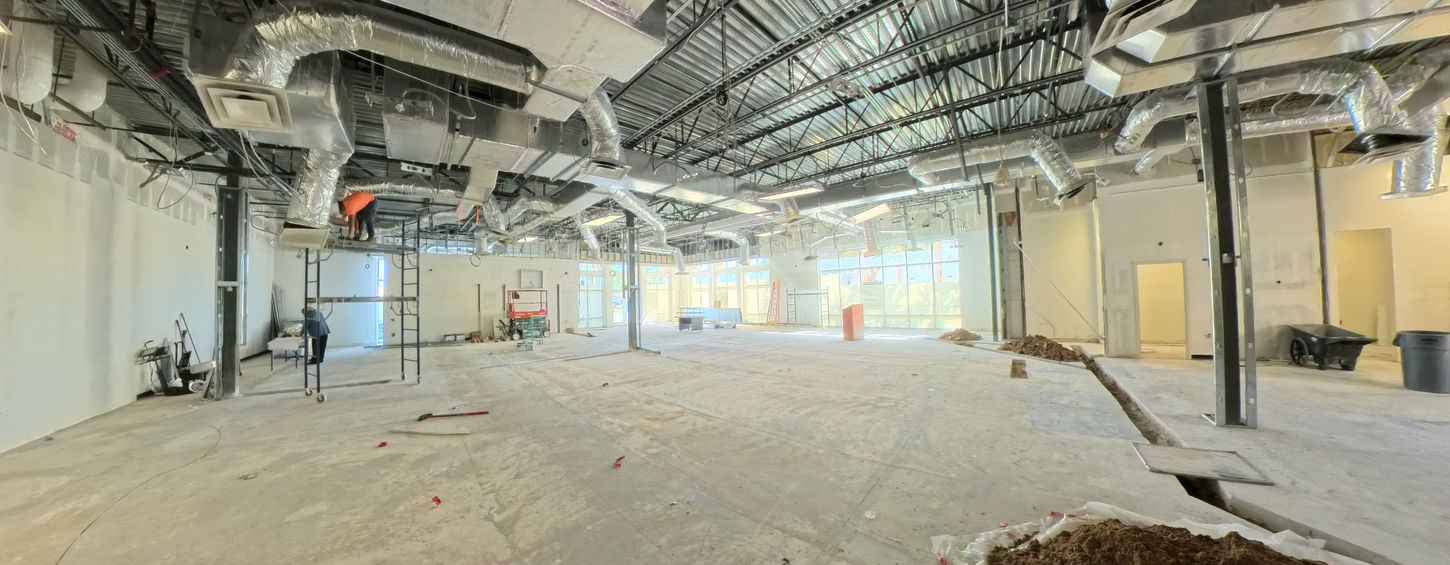 Bonita Springs commercial interior during construction showing HVAC ductwork and structural columns.