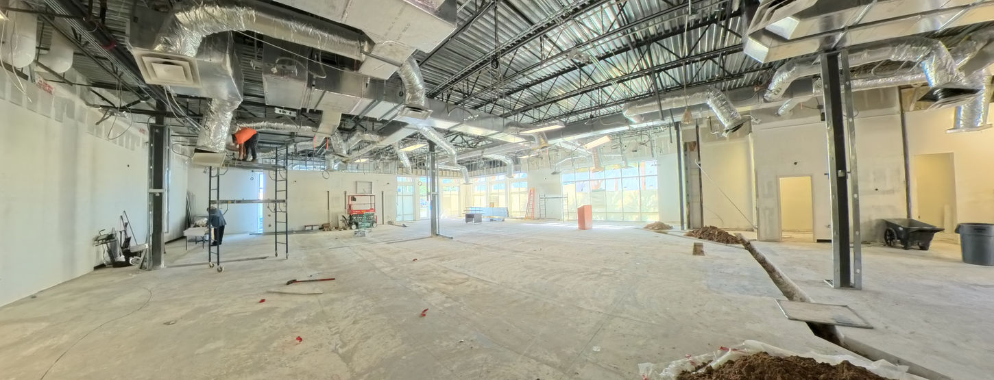 Bonita Springs commercial interior during construction showing HVAC ductwork and structural columns.