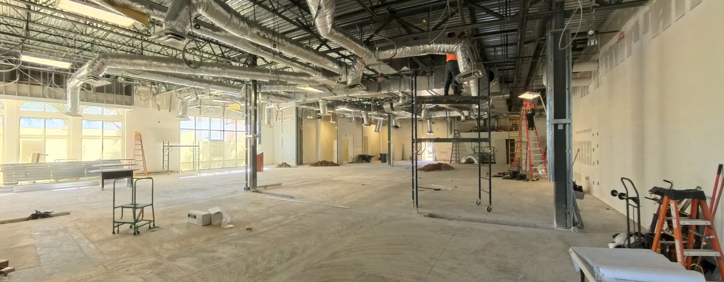 Retail tenant build-out in progress with exposed mechanical systems in Bonita Springs Florida.