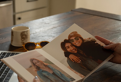 Handcover photo book by SimplePrintswith images of a mom hugging the daughter and a candid picture of a happy women