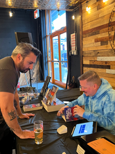 Signing Between the Waves and the Stars for attendees at Flagship Brewery during the book’s release celebration.