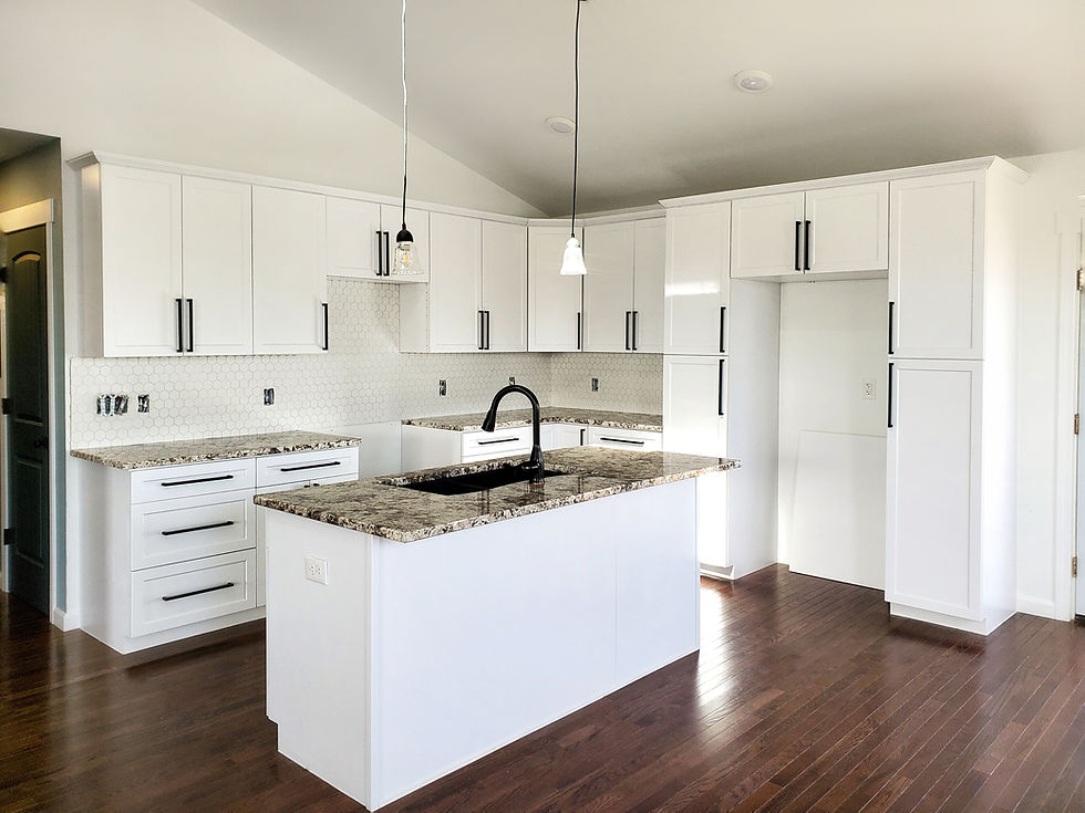 Oxford Kitchen. Quartz counter tops, pendent lighting, island sink, vaulted ceiling, craftsman trim.