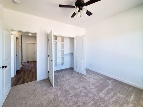 Fitzgerald bedroom 1. Custom closet, carpet, ceiling fan.