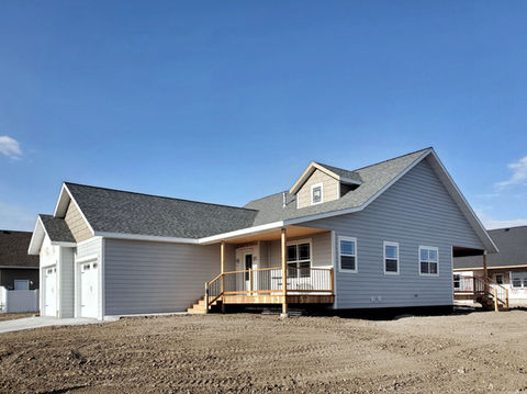 Oxford Side View. Covered porch, wood deck, and 2 car garage.