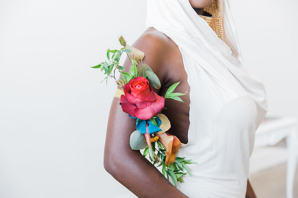 a unique floral piece attached to the bride's arm