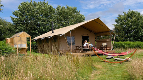 Group safari lodge luxury glamping in Pembrokeshire at Top of the Woods, with private deck, hammock and space to relax together