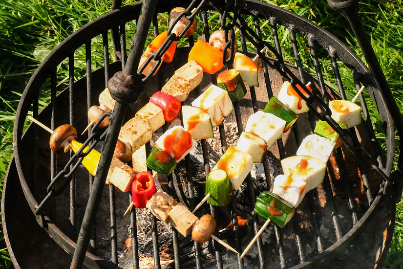 Food and eating at Top of the Woods, with guests cooking fresh local ingredients over a campfire BBQ during an eco luxury glamping and camping holiday in Pembrokeshire, Wales.