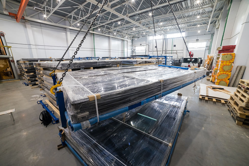 Stacks of high efficiency solar panels stored on pallets inside a module warehouse