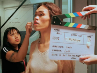 Makeup is being put on a woman shooting for a film