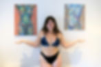 Feminist artist Isabelle Sophia Art posing in front of her nude body positivity artwork in Bristol
