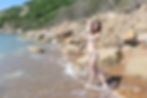 Hula hoop performer, Laura Loops, posing naked on the beach with her hoops during an interview and photoshoot with Britain Uncovered